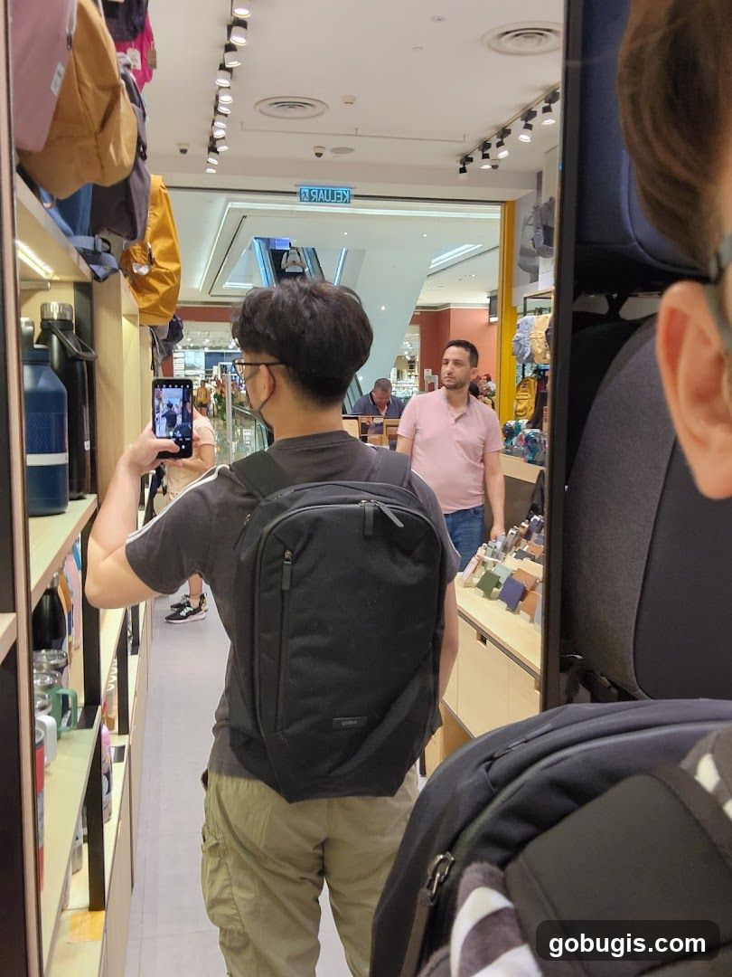 Man taking a mirror selfie in a store