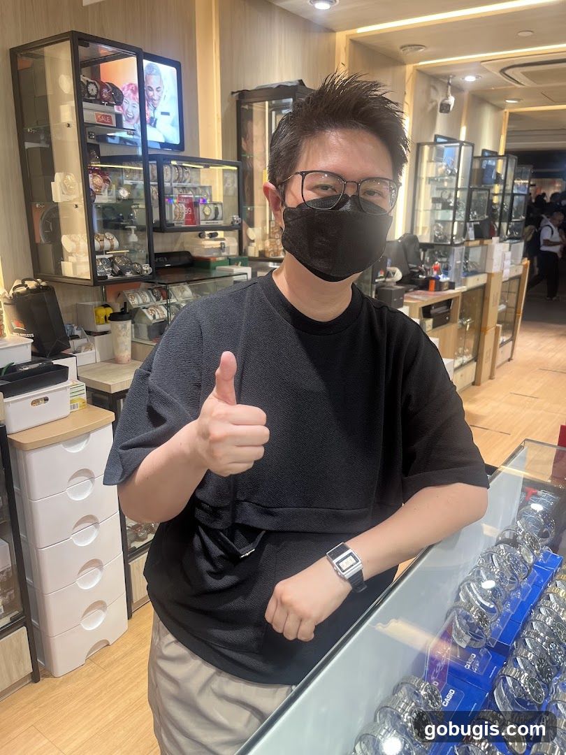 Person giving a thumbs up in a watch store