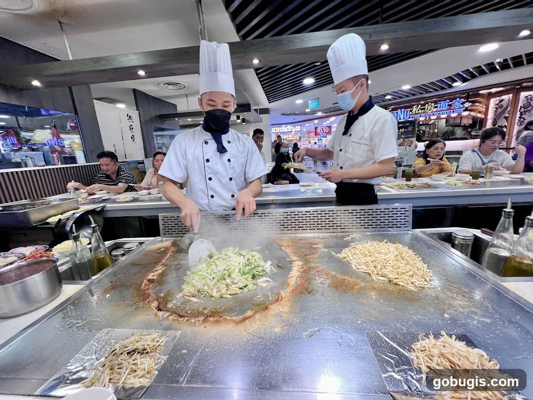 Chefs cooking at a teppanyaki grill