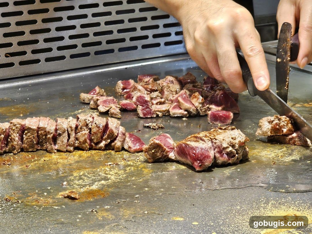Chef Slicing Steak on a Griddle