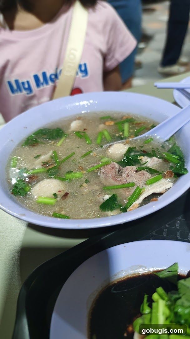 Bowl of Soup with Meatballs and Greens