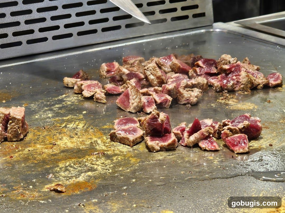 Steak being cooked on a griddle