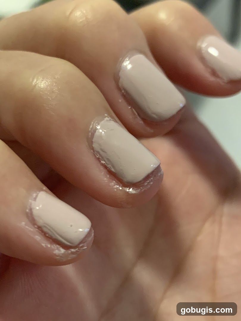 Close-up of fingernails with light beige polish