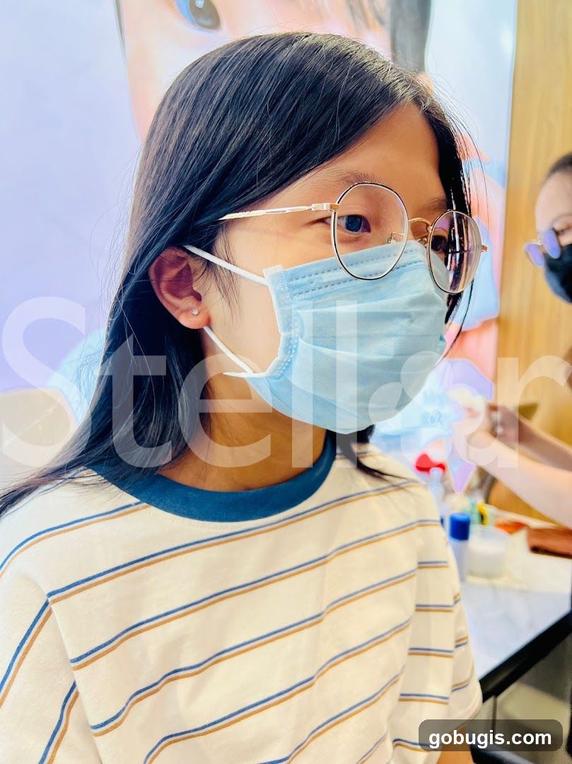Girl getting ear piercing