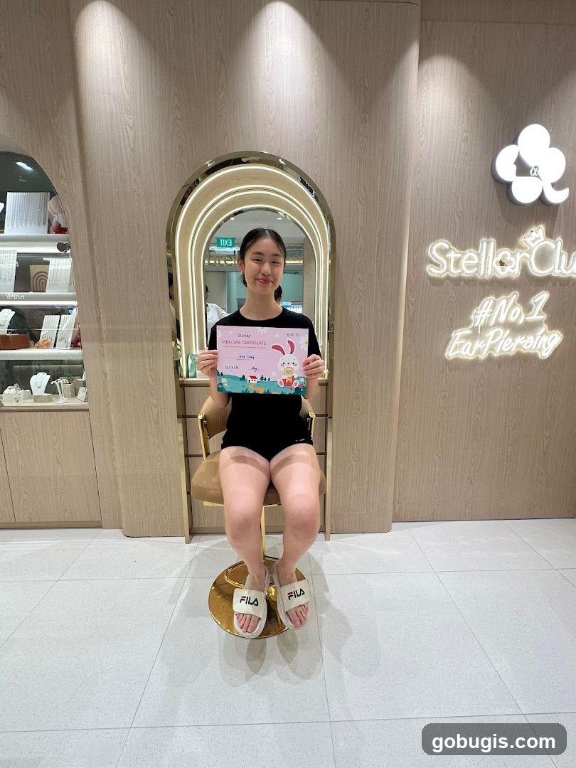 Young woman holding a piercing certificate