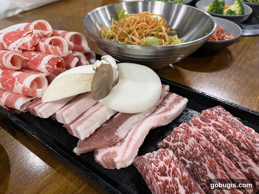 Assortment of Raw Meats and Side Dishes