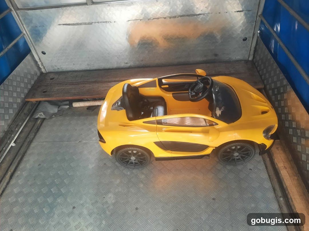 Yellow toy car in a truck