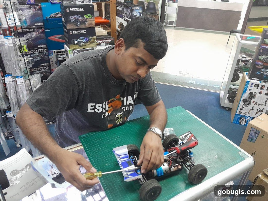 Man Assembling a Remote Control Car