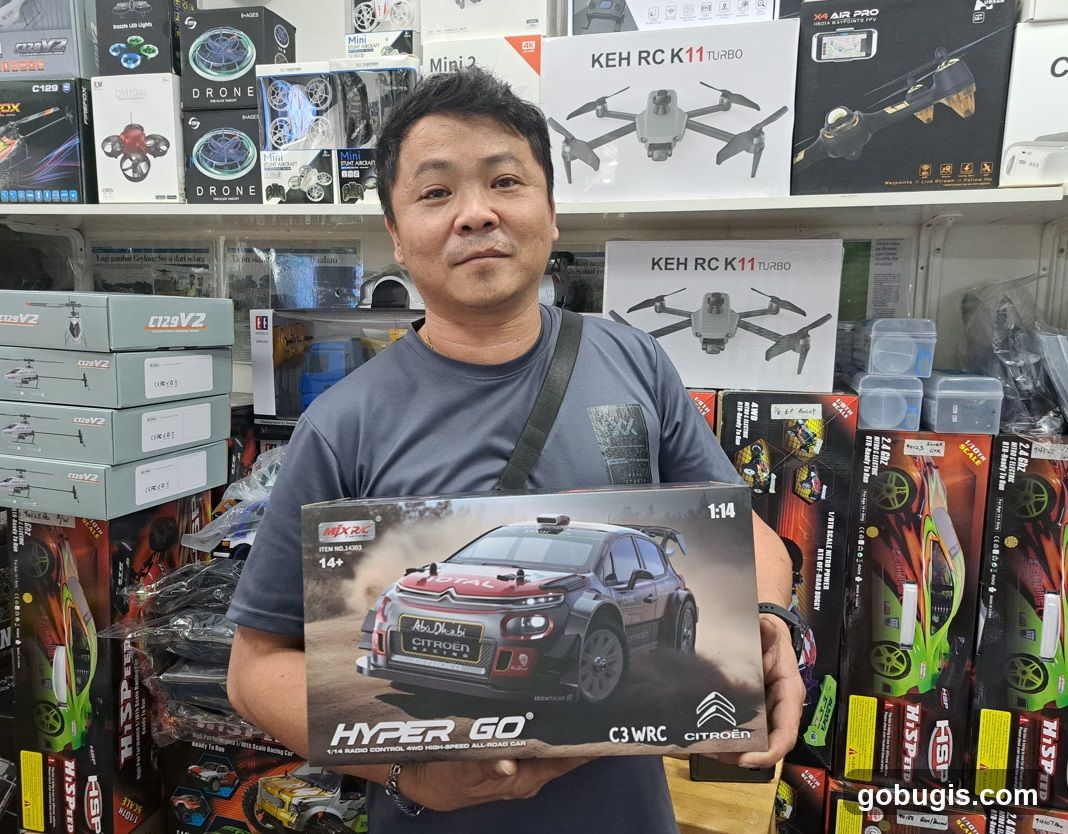 Man holding a remote-controlled car box