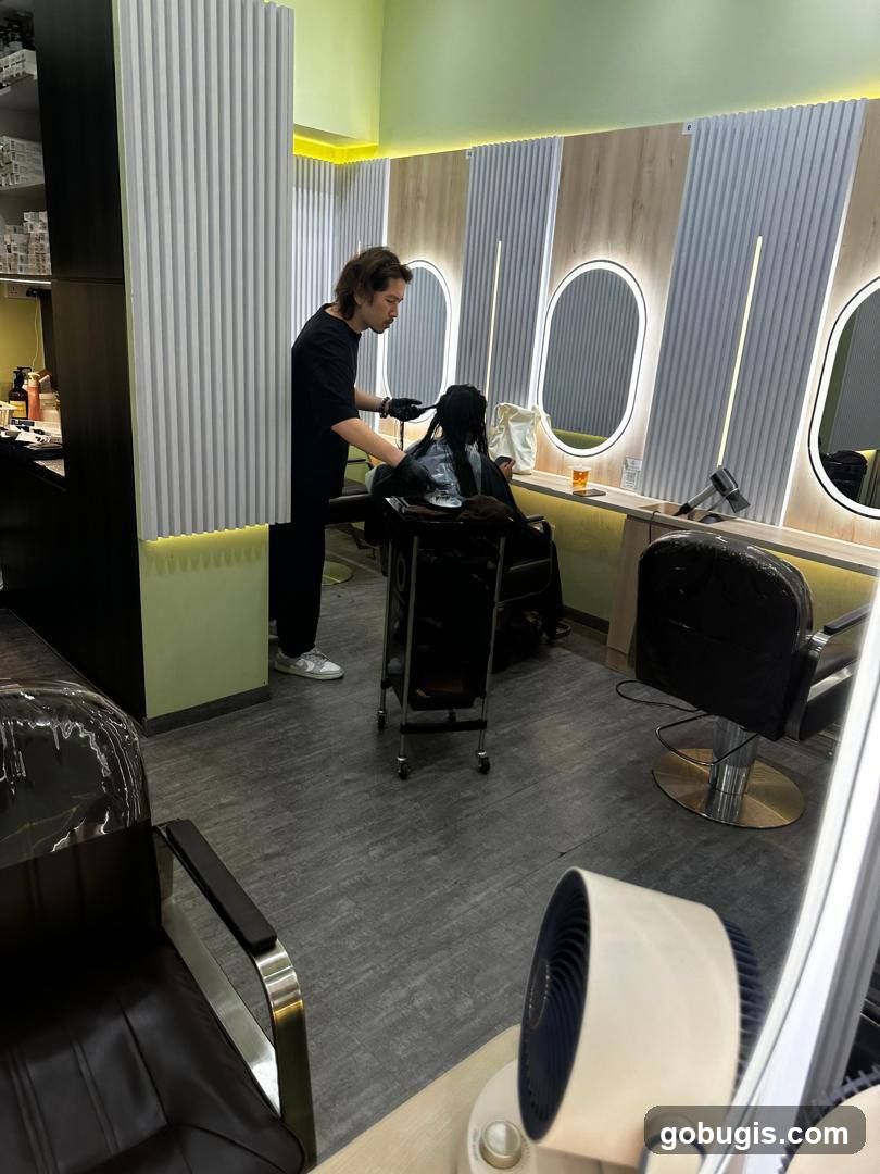 Hairdresser working on client