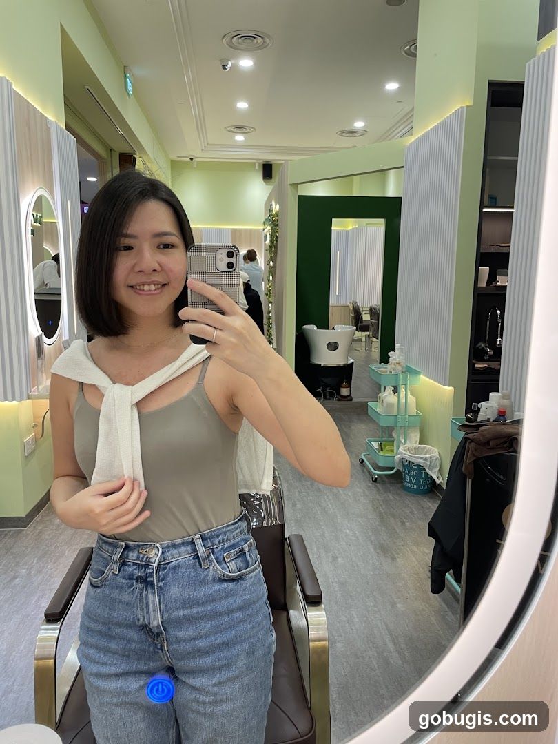 Woman taking a mirror selfie in a salon