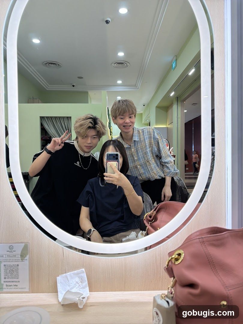 Three people taking a selfie in a salon mirror