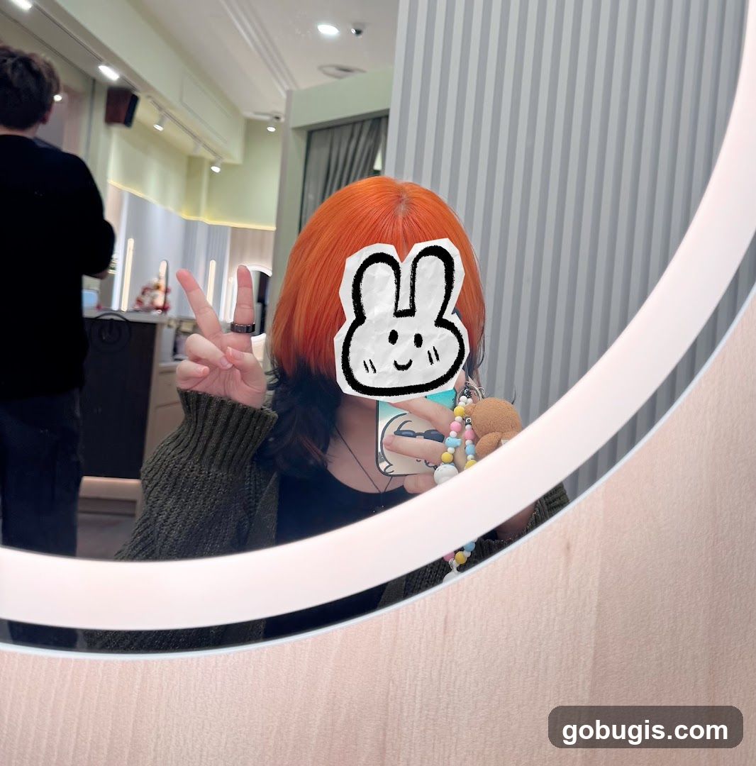 Person with dyed hair taking a mirror selfie