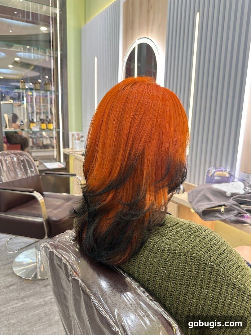 Woman with orange and black dyed hair