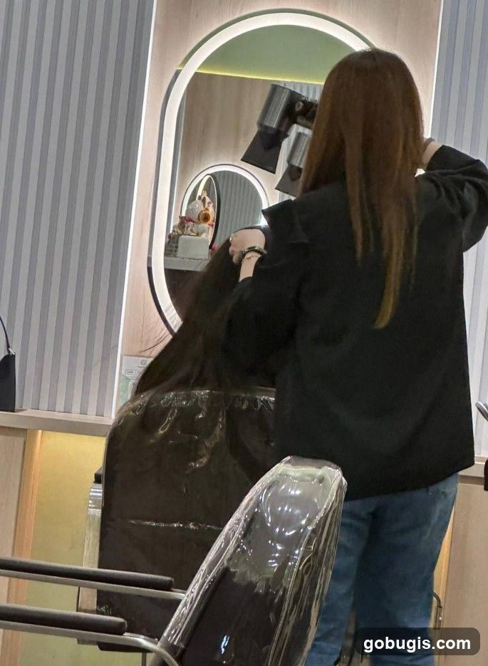 Hairdresser drying client's hair