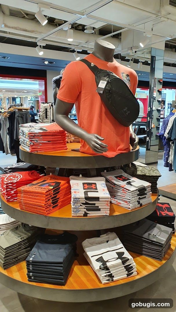 Mannequin wearing orange t-shirt and sling bag