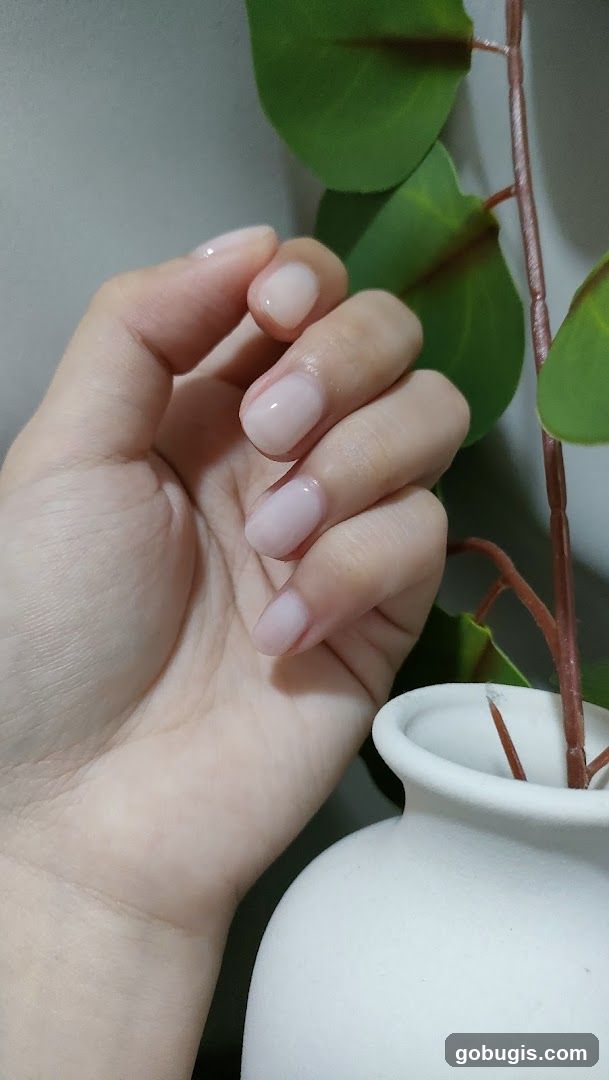 Hand with light pink nails