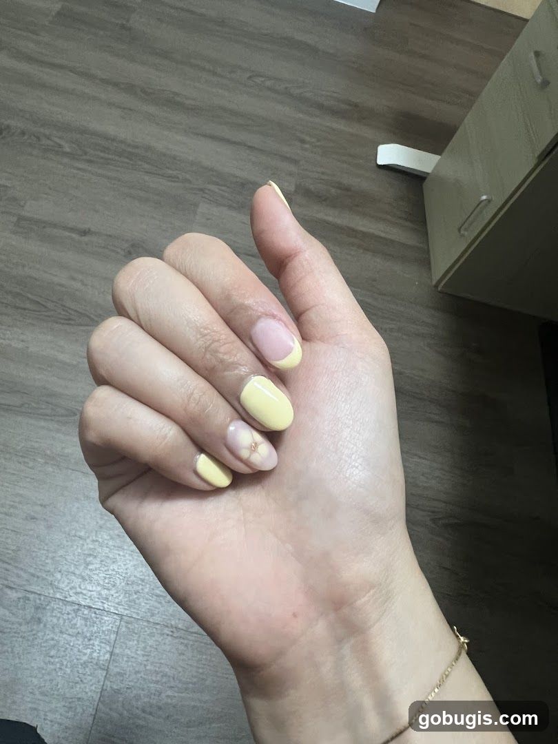 Yellow French Tip Nails with Floral Accent