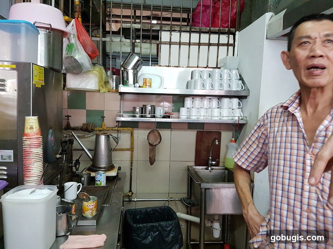 Man in a checkered shirt in a food stall