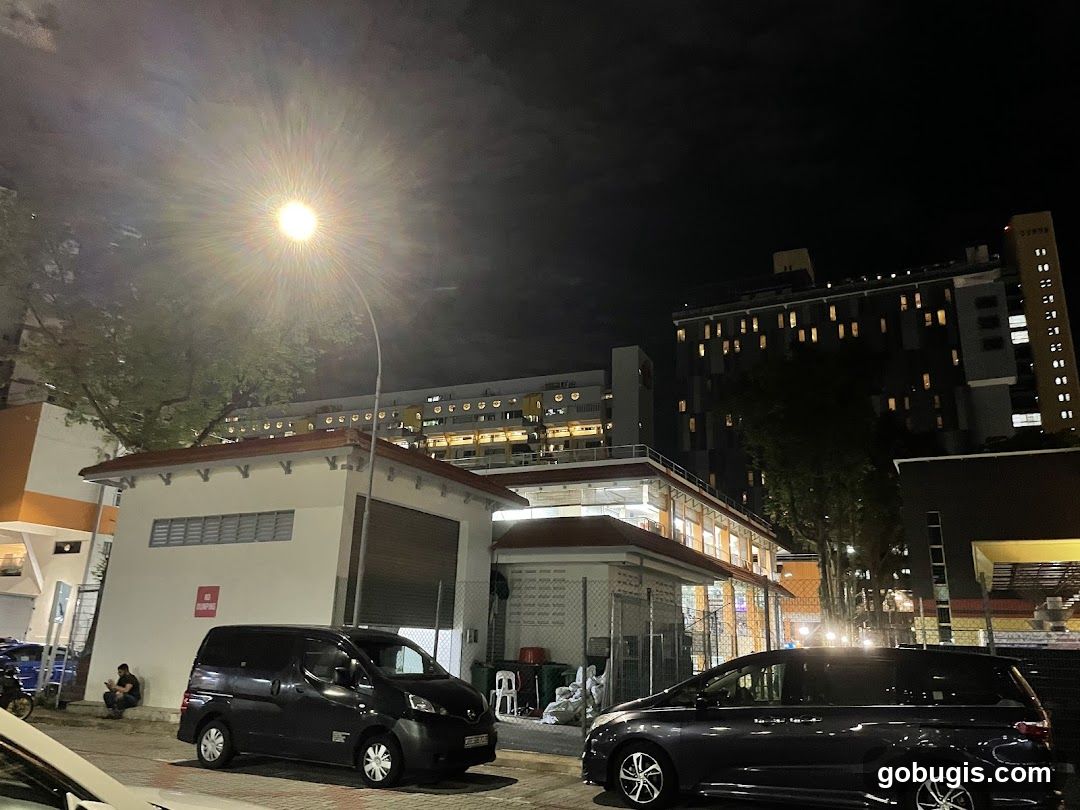 Nighttime street scene with buildings and vehicles