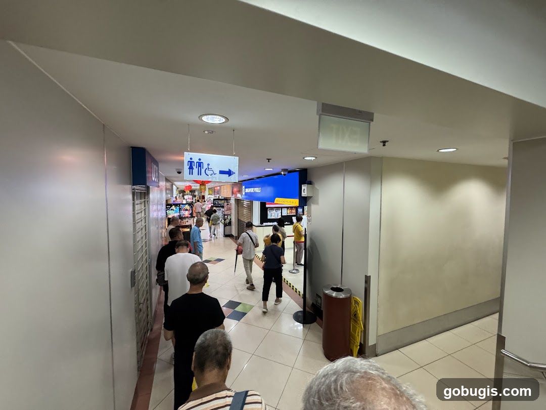 People in a queue at a Singapore Pools outlet