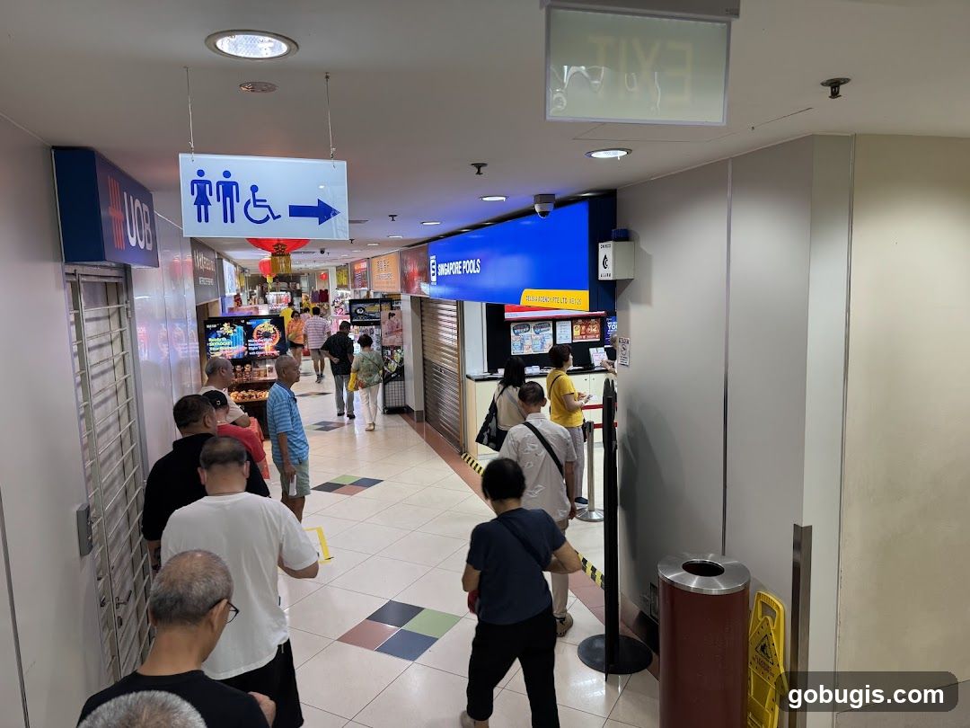 People queuing in a mall corridor