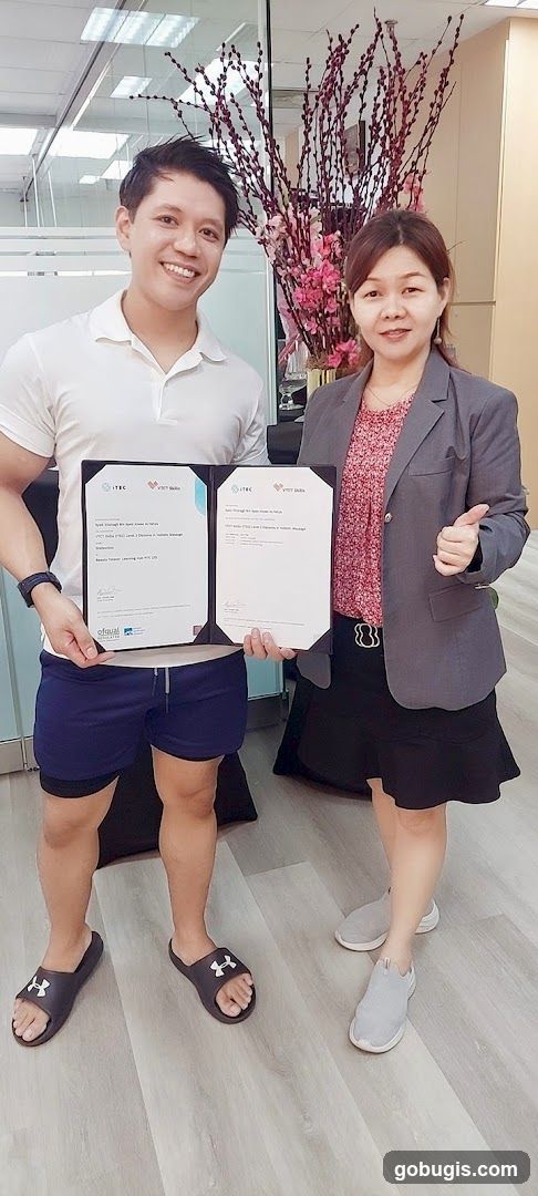 Two people holding certificates