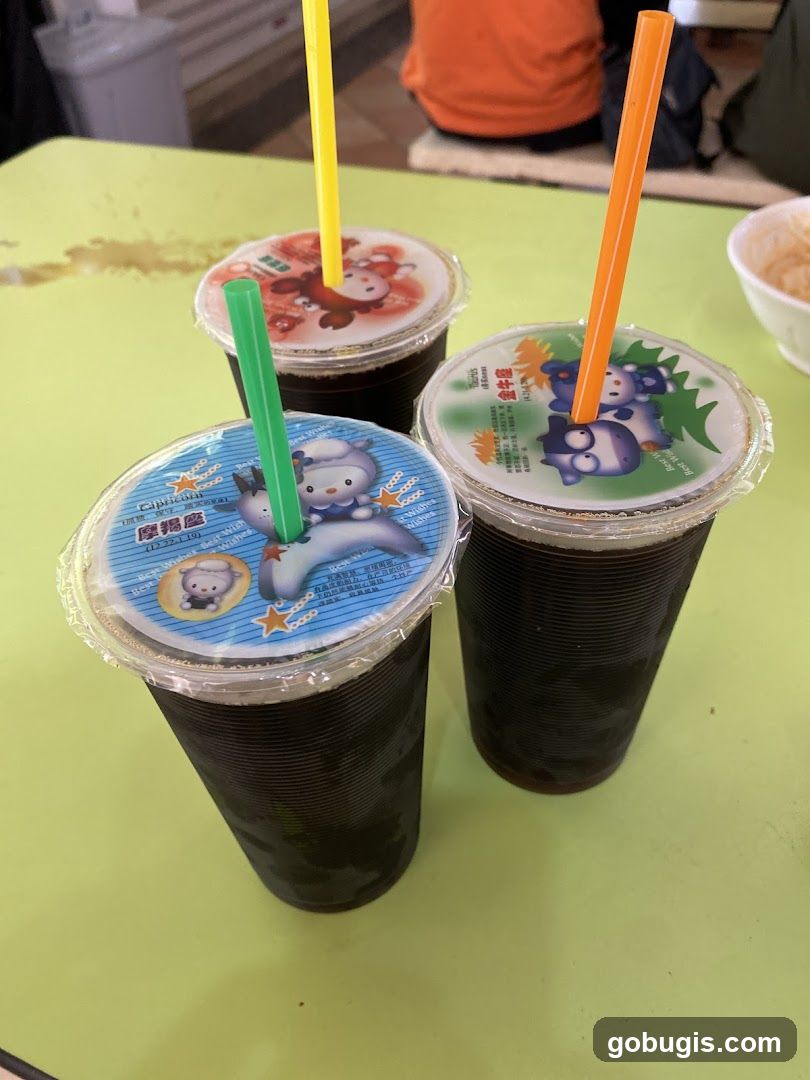 Three drinks with cartoon lids