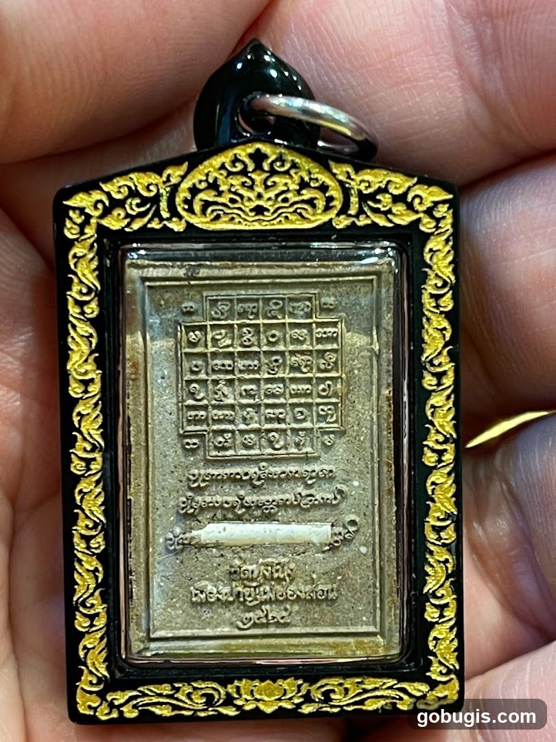 Amulet with Thai Script and Grid Pattern