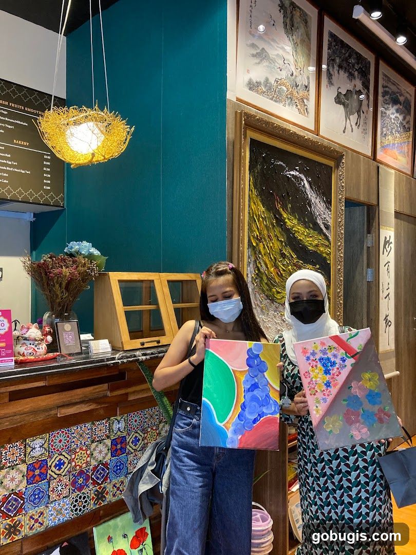 Two Women Holding Paintings