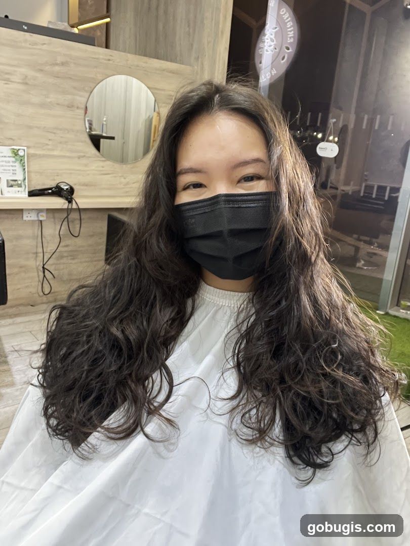 Woman with long curly hair at a salon