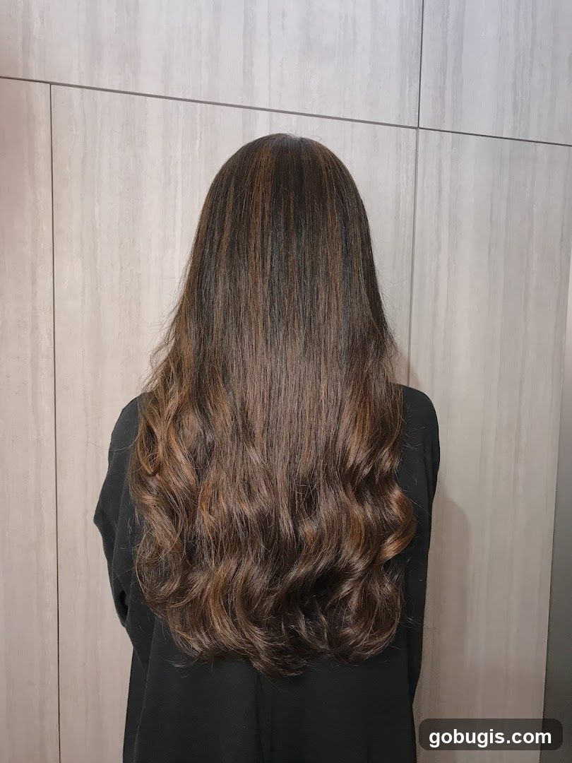Woman with long, wavy, highlighted hair