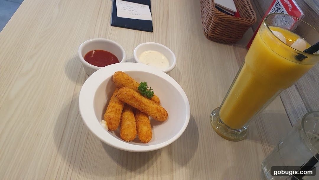 Cheese sticks with dipping sauces and a mango smoothie