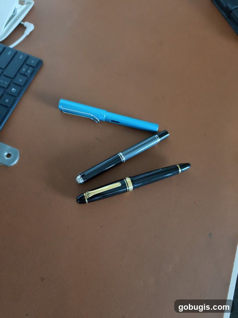 Three pens on a desk