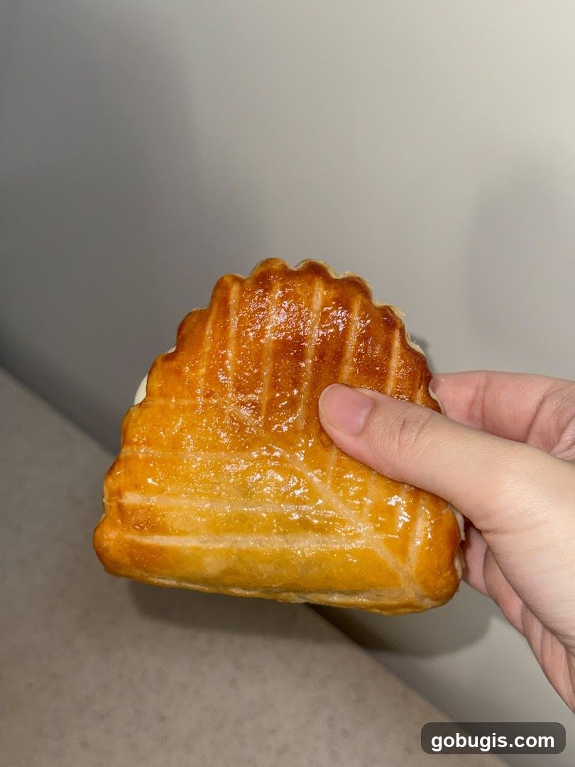 Hand Holding a Pastry