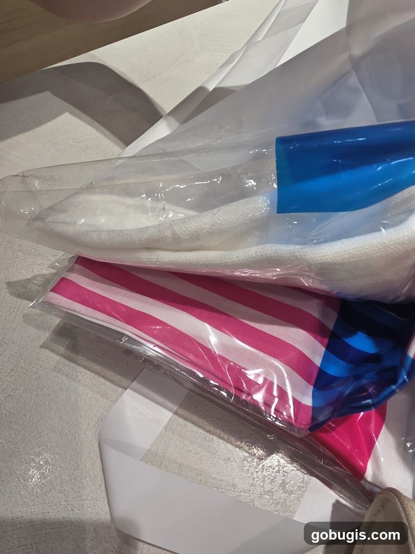 Striped Fabric and White Towel in Plastic Packaging