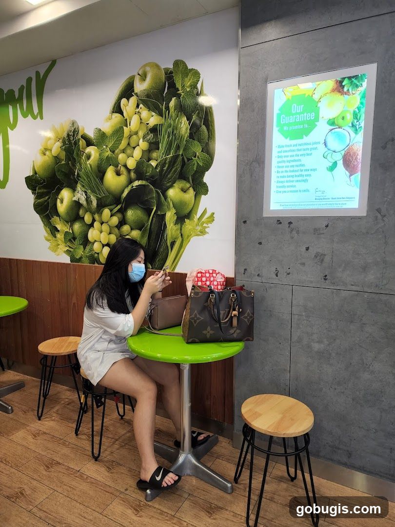 Woman sitting at a table in a juice bar