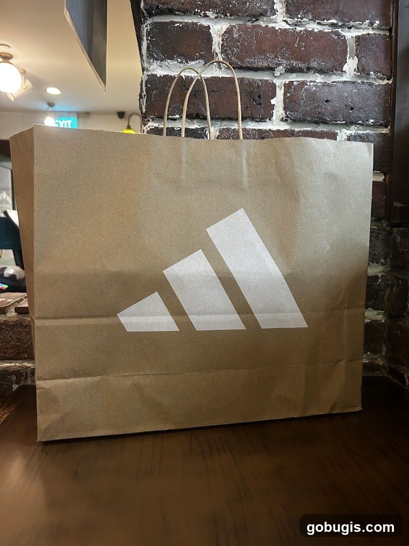 Brown paper shopping bag with Adidas logo