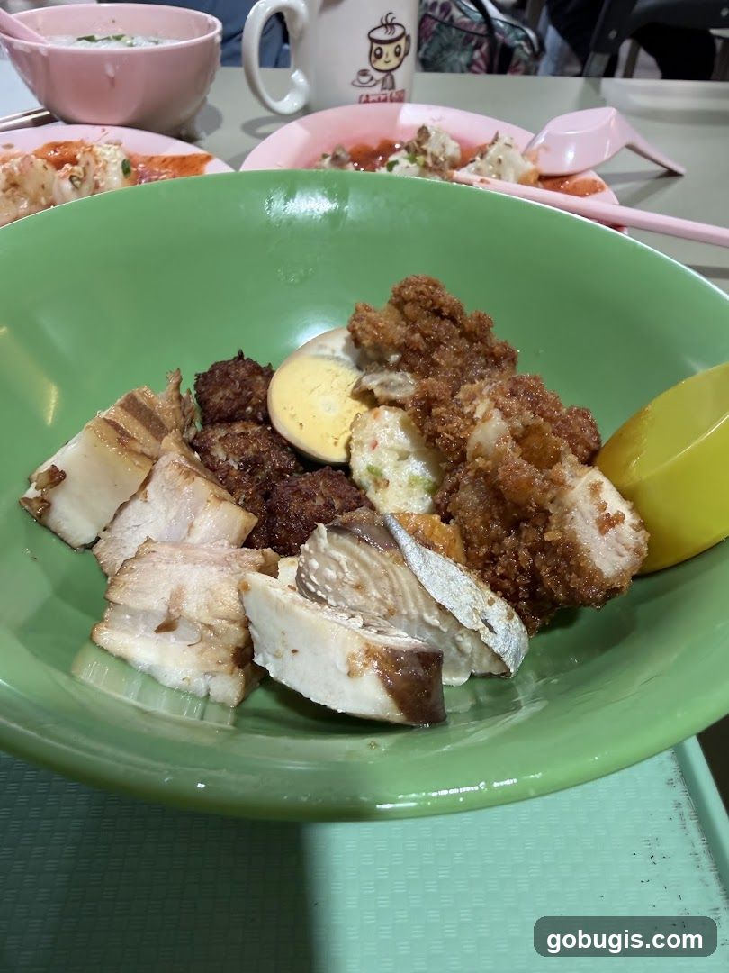 Bowl of food with various meats and egg