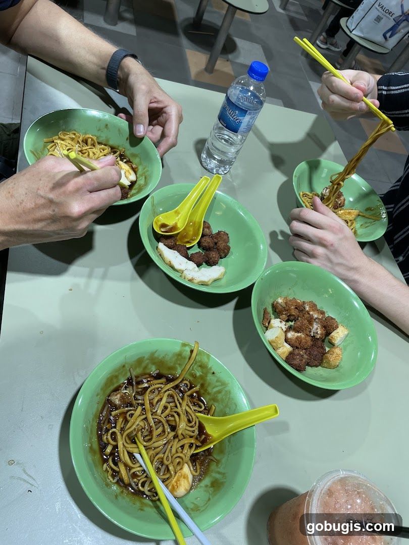People eating noodles at a food stall