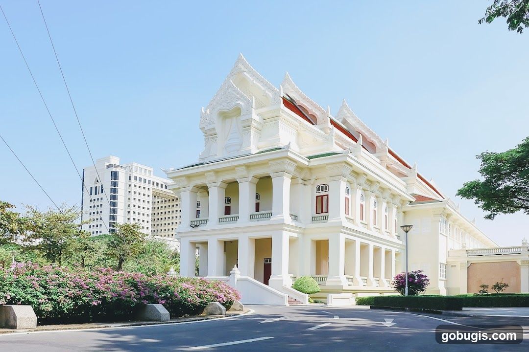 Ornate White Building with Modern High-Rise in Background