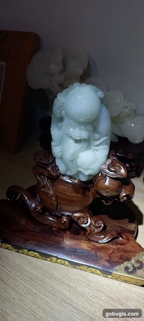 Jade Figurine on Wooden Stand