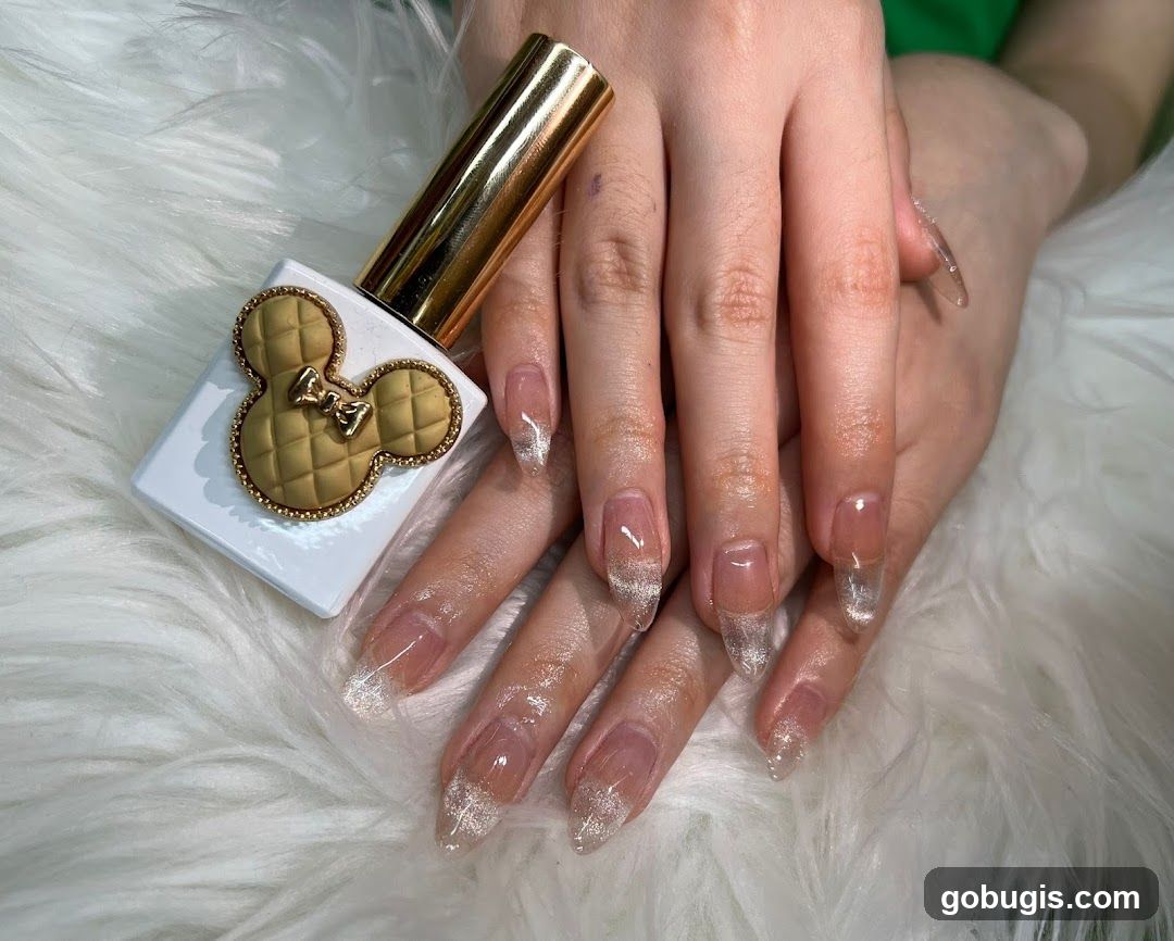 Nail Polish Bottle and Manicured Nails