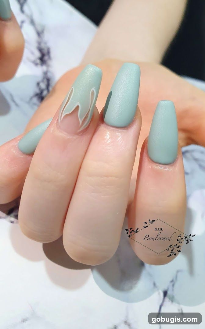Matte Mint Green Coffin Nails with Flame Design