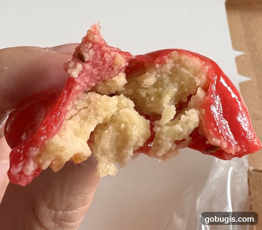 Close-up of a broken cookie with red icing