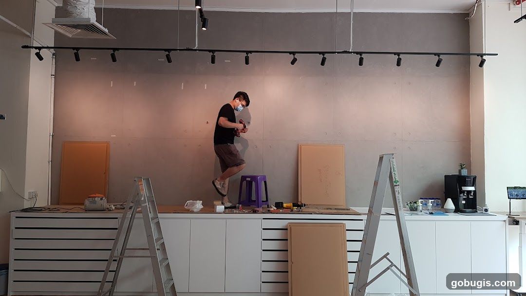 Man Drilling into Wall