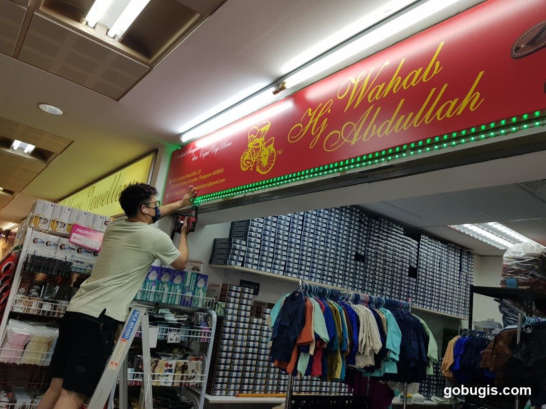 Installing Lights Above Store Signage
