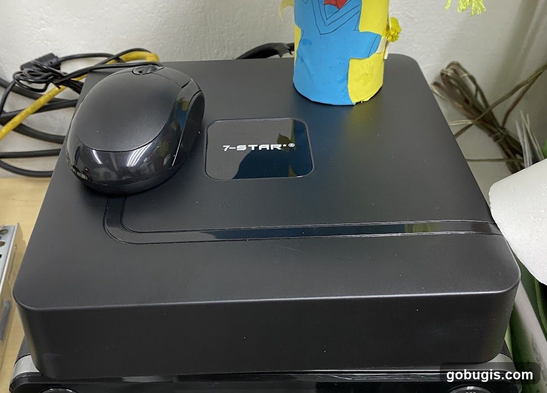 Black computer mouse on top of a black electronic device