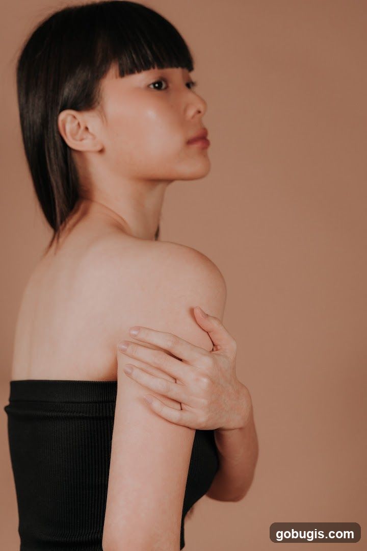 Woman with bangs touching her arm