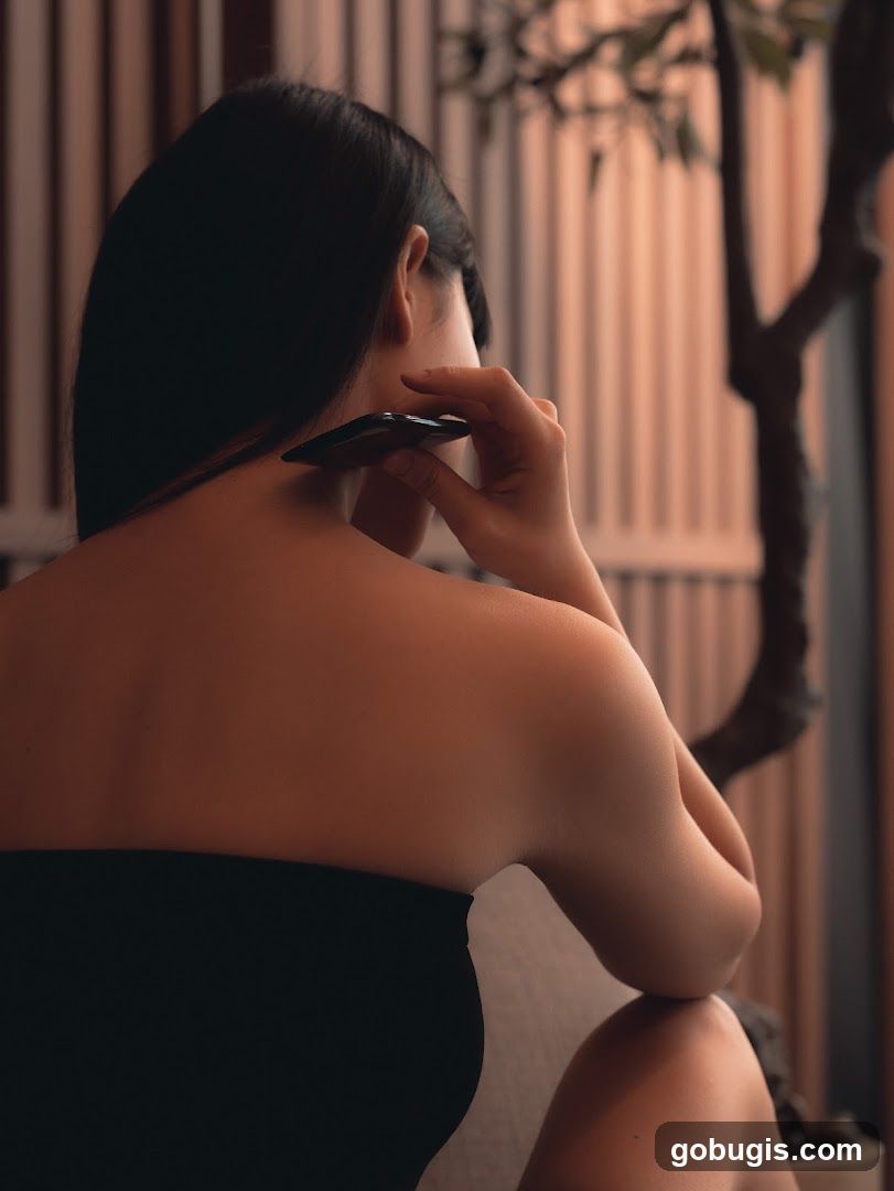 Woman performing Gua Sha on her neck
